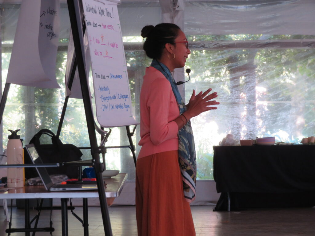 Pri, a senior associate at ICL, stands in front of a group she's facilitating